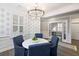 Bright dining room featuring an elegant chandelier, shuttered windows, and hardwood flooring at 1918 Essex Farms Dr, Charleston, SC 29414