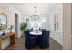 Elegant dining room features designer wallpaper, modern chandelier, and hardwood floors at 1918 Essex Farms Dr, Charleston, SC 29414