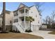 Charming two-story coastal home with double porches, a palm tree, and well-maintained landscaping at 1918 Essex Farms Dr, Charleston, SC 29414