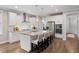Modern kitchen featuring white cabinets, stainless steel appliances, and a marble island with bar seating at 1918 Essex Farms Dr, Charleston, SC 29414