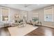 Bright living room with natural light, modern decor, and hardwood floors offering a welcoming ambiance at 1918 Essex Farms Dr, Charleston, SC 29414