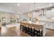 Elegant living room with a kitchen view featuring an open layout, providing seamless flow for modern living at 1918 Essex Farms Dr, Charleston, SC 29414