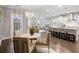 Bright and airy living area with hardwood floors, large windows, and an open concept to the kitchen at 1918 Essex Farms Dr, Charleston, SC 29414