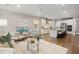 Inviting living room with hardwood floors, neutral tones, and an open layout connecting to the kitchen at 1918 Essex Farms Dr, Charleston, SC 29414