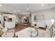 The living room is open to the kitchen and dining room with hardwood floors and modern lighting at 1918 Essex Farms Dr, Charleston, SC 29414