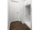 Well-organized mudroom with white cabinetry, a bench, and hardwood flooring at 1918 Essex Farms Dr, Charleston, SC 29414