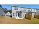 Rear view of home showcasing backyard with fenced in area and cement patio at 211 Abercom Place Dr, Moncks Corner, SC 29461
