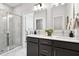 Stylish bathroom boasts marble shower, double sink vanity with dark cabinets, and modern fixtures at 211 Abercom Place Dr, Moncks Corner, SC 29461