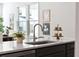 Modern kitchen sink with stainless steel faucet, quartz countertop, and decorative accents at 211 Abercom Place Dr, Moncks Corner, SC 29461