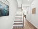 Staircase featuring hardwood steps, a white riser, and views of the home's decor at 211 Abercom Place Dr, Moncks Corner, SC 29461