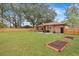 Wide shot of a beautiful backyard with a brick home, privacy fence, and a well-manicured lawn at 201 Maple Dr, Summerville, SC 29485