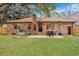 Backyard featuring a brick home, a concrete patio, and a well-manicured lawn at 201 Maple Dr, Summerville, SC 29485