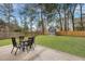 Spacious backyard features a patio with an outdoor dining set and a charming playhouse at 201 Maple Dr, Summerville, SC 29485