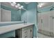 Modern bathroom with a large mirror, sleek vanity, and glass-enclosed shower at 201 Maple Dr, Summerville, SC 29485