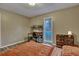 Comfortable bedroom with a large bed, a wood-look floor, and a small workstation near the window at 201 Maple Dr, Summerville, SC 29485