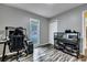 Bedroom with a large window and a gaming computer table, light-gray walls, and wood-look floors at 201 Maple Dr, Summerville, SC 29485