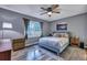 Relaxing bedroom with a large window, ceiling fan, and soft rug at 201 Maple Dr, Summerville, SC 29485