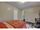 Cozy bedroom featuring a large bed with orange bedspread, wood-look floors, and interior door and closet at 201 Maple Dr, Summerville, SC 29485