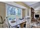 Inviting dining area with a view of the backyard, featuring a wooden table, chairs, and access to the living room at 201 Maple Dr, Summerville, SC 29485