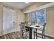 Bright dining area with a large window offering outdoor views, complemented by a rustic wooden table and chairs at 201 Maple Dr, Summerville, SC 29485