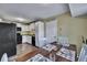 Cozy dining area adjacent to the kitchen, featuring a wooden table set for a meal and bright natural light at 201 Maple Dr, Summerville, SC 29485