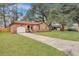 Charming brick home with a well-manicured lawn and a long driveway leading to the attached garage at 201 Maple Dr, Summerville, SC 29485