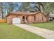 Charming brick home features an attached garage, arched doorways, and a well-manicured lawn at 201 Maple Dr, Summerville, SC 29485