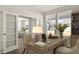 Well-lit home office with a functional desk, comfortable chairs, and French doors at 202 Belfort Pl, Summerville, SC 29486