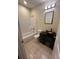 Bathroom featuring a shower-tub combo, toilet, dark vanity with bowl sink, mirror, and modern lighting at 2100 Booker St, Charleston, SC 29405