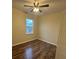 Bedroom featuring a ceiling fan, wood-look floors, neutral walls, and a window with natural light at 2100 Booker St, Charleston, SC 29405