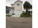Two story home with an attached garage and a covered front porch and stairs at 2100 Booker St, Charleston, SC 29405