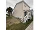Side exterior view of the home with a deck, stairs, palm tree, and grassy yard at 2100 Booker St, Charleston, SC 29405