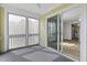 View from the screened-in balcony looking into the living room with sliding glass door entry at 2333 Tall Sail Dr # G 607, Charleston, SC 29414