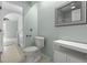 Bright bathroom with a modern toilet, white shelving unit and framed mirror that enhances the clean, streamlined space at 2333 Tall Sail Dr # G 607, Charleston, SC 29414