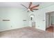 Primary bedroom features light green walls, a ceiling fan, and a view into the bathroom at 2333 Tall Sail Dr # G 607, Charleston, SC 29414