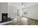 Cozy living room with wood floors, fireplace, ceiling fan, and access to the outdoor balcony at 2333 Tall Sail Dr # G 607, Charleston, SC 29414