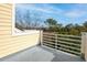 A cozy covered yellow patio, perfect for outdoor relaxation and overlooks serene surroundings and mature trees at 2333 Tall Sail Dr # G 607, Charleston, SC 29414