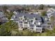Rear exterior view of the multi-level home with balconies and landscaped yard at 2333 Tall Sail Dr # G 607, Charleston, SC 29414