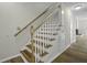 Staircase featuring light wood steps and handrail, white risers, and a small under-stair door at 2333 Tall Sail Dr # G 607, Charleston, SC 29414