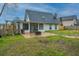 Backyard with a patio, fire pit, and newly-installed wooden fence; perfect for outdoor enjoyment at 240 Horseshoe Dr, Goose Creek, SC 29445