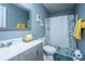 Cozy bathroom with updated vanity, stylish floral shower curtain, and modern blue wall color at 240 Horseshoe Dr, Goose Creek, SC 29445