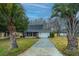 Charming home with a well-manicured lawn and mature palm trees, offering a welcoming curb appeal at 240 Horseshoe Dr, Goose Creek, SC 29445