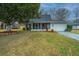 Charming single-story home with a landscaped front yard, mature tree, and a screened-in porch at 240 Horseshoe Dr, Goose Creek, SC 29445