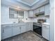 Modern kitchen features sleek gray cabinets, stainless steel appliances, and a bright window at 240 Horseshoe Dr, Goose Creek, SC 29445