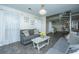 Bright living room features modern furniture, sheer curtains, and access to a spiral staircase at 240 Horseshoe Dr, Goose Creek, SC 29445