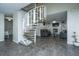 Open floor plan with tiled floors features a spiral staircase leading to an upstairs living room at 240 Horseshoe Dr, Goose Creek, SC 29445