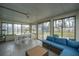 Enclosed sun room offering a cozy seating area with a blue couch and dining set at 240 Horseshoe Dr, Goose Creek, SC 29445