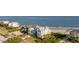 Aerial view of a luxurious beachfront property with lush landscaping at 3001 Marshall Blvd, Sullivans Island, SC 29482