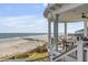 Expansive balcony overlooking a beautiful beach with outdoor seating for relaxing and entertaining at 3001 Marshall Blvd, Sullivans Island, SC 29482