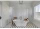 Bright bathroom features a soaking tub, shower, tiled floors, and natural light from a window at 3001 Marshall Blvd, Sullivans Island, SC 29482